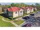 Exterior view of condos with well-manicured lawns and reserved parking spaces at 9481 Highland Oak Dr # 404, Tampa, FL 33647
