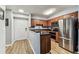 Modern kitchen with stainless steel appliances, dark countertops, and wood cabinets at 9481 Highland Oak Dr # 404, Tampa, FL 33647