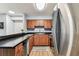 Close up view of kitchen featuring stainless steel refrigerator and wood cabinets at 9481 Highland Oak Dr # 404, Tampa, FL 33647