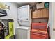 Laundry area with stacked washer/dryer and a red toolbox at 9481 Highland Oak Dr # 404, Tampa, FL 33647