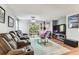 Comfortable living room featuring reclining leather sofas and access to outdoor space at 9481 Highland Oak Dr # 404, Tampa, FL 33647