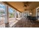 Covered patio area with tile flooring, ceiling fans, and outdoor seating at 9481 Highland Oak Dr # 404, Tampa, FL 33647