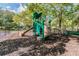 Fun playground featuring a slide, climbing structures, and soft ground cover for safe playtime in a park-like setting at 9481 Highland Oak Dr # 404, Tampa, FL 33647