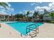Resort-style pool with comfortable lounge chairs and lush landscaping, perfect for relaxation and enjoying the beautiful surroundings at 9481 Highland Oak Dr # 404, Tampa, FL 33647