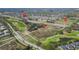 An aerial view shows the property's location near a golf course, trails, and residential areas with convenient access to highways at 9873 Trumpet Vine Loop, Trinity, FL 34655
