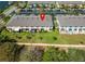 Aerial view of townhouses with well-maintained lawns, patios and manicured landscaping at 9873 Trumpet Vine Loop, Trinity, FL 34655