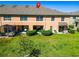 Spacious backyard with screened patio, lush lawn and mature shrubbery at townhouse at 9873 Trumpet Vine Loop, Trinity, FL 34655