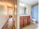 Well-lit bathroom featuring modern fixtures, a vanity, and a view into the adjacent bedroom, designed for comfort and convenience at 9873 Trumpet Vine Loop, Trinity, FL 34655