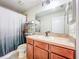 Functional bathroom with a single sink vanity, a large mirror, and a shower with a modern shower curtain at 9873 Trumpet Vine Loop, Trinity, FL 34655