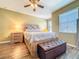 Bright, well-lit bedroom with ceiling fan and ample natural light at 9873 Trumpet Vine Loop, Trinity, FL 34655