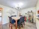 An elegant dining room with a table set for six, complemented by a bar area and stylish decor, perfect for entertaining at 9873 Trumpet Vine Loop, Trinity, FL 34655