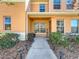 Inviting home exterior featuring a well-manicured lawn, lush landscaping, and a welcoming entrance at 9873 Trumpet Vine Loop, Trinity, FL 34655