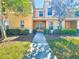 Charming two-story home with a well-maintained lawn and inviting walkway, great curb appeal at 9873 Trumpet Vine Loop, Trinity, FL 34655