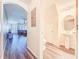 Hallway view leads into the living room and powder room, complete with wood-look floors at 9873 Trumpet Vine Loop, Trinity, FL 34655