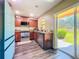 Well-lit kitchen with stainless steel appliances, granite countertops, and a sliding door leading to the backyard at 9873 Trumpet Vine Loop, Trinity, FL 34655