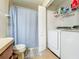 Functional laundry room featuring a washer, dryer, and a shower/tub with curtain at 9873 Trumpet Vine Loop, Trinity, FL 34655