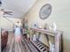 Inviting living room hallway featuring wood floors, a stylish console table, and decor for a cozy and modern feel at 9873 Trumpet Vine Loop, Trinity, FL 34655