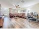 Spacious living room featuring wood flooring, a large sectional sofa, and an open layout for comfortable living at 9873 Trumpet Vine Loop, Trinity, FL 34655