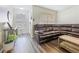 Cozy living area with a comfortable leather sofa, wood-look floors, and bright windows at 9873 Trumpet Vine Loop, Trinity, FL 34655