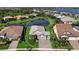 Aerial view of home with manicured lawn, landscaping, and a view of the lake at 809 Seascape Pl, Sarasota, FL 34240