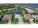 Beautiful aerial view of a well-manicured home in a lakeside community with lush landscaping at 809 Seascape Pl, Sarasota, FL 34240