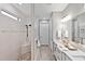 Modern bathroom with walk-in shower, double vanity, and neutral color palette at 809 Seascape Pl, Sarasota, FL 34240