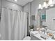 Bathroom featuring a shower with gray subway tile surround, vanity, and decorative accents at 809 Seascape Pl, Sarasota, FL 34240