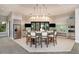 Elegant dining area with a spacious table and modern lighting fixtures at 809 Seascape Pl, Sarasota, FL 34240