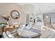 Stylish dining area with a unique light fixture, decorative mirror, and a view into the modern kitchen at 809 Seascape Pl, Sarasota, FL 34240