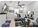 Well-equipped exercise room with a treadmill, stationary bike, and mounted television at 809 Seascape Pl, Sarasota, FL 34240