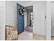 Welcoming foyer with a stylish front door, elegant wall paneling, and a glimpse of the outdoor view at 809 Seascape Pl, Sarasota, FL 34240