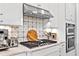 Modern kitchen featuring stainless steel appliances, custom backsplash, and gas cooktop at 809 Seascape Pl, Sarasota, FL 34240