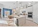 Open kitchen boasts a large island with a wine fridge, stainless appliances, and pendant lighting at 809 Seascape Pl, Sarasota, FL 34240