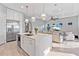Bright, open kitchen featuring stainless steel appliances, an island with seating, and a large refrigerator at 809 Seascape Pl, Sarasota, FL 34240