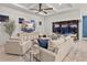 Spacious living room featuring a cozy sectional, modern TV, and seamless access to the lanai at 809 Seascape Pl, Sarasota, FL 34240