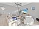 Well-lit living room with neutral decor, large sectional sofa, and modern entertainment center at 809 Seascape Pl, Sarasota, FL 34240
