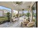 Cozy screened outdoor seating area with comfortable furniture, offering serene views of the surrounding landscape at 809 Seascape Pl, Sarasota, FL 34240