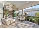 Inviting patio with wicker seating, tile flooring, and a serene outdoor view at 809 Seascape Pl, Sarasota, FL 34240