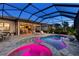 Sparkling pool and hot tub with color lights, and an expansive screened-in lanai at 809 Seascape Pl, Sarasota, FL 34240