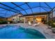 Private screened-in pool with spacious patio and sun loungers at 809 Seascape Pl, Sarasota, FL 34240