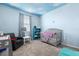 Charming bedroom with a cloud-painted ceiling, cozy decor, and plush carpeting at 1002 Rose Blossom Ct, Tampa, FL 33613