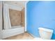 Bathroom featuring a shower-tub combo with tiled walls complemented by modern fixtures and neutral flooring at 101 N 12Th St # 306, Tampa, FL 33602