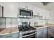 Updated kitchen features stainless steel appliances, granite countertops, and a sleek subway tile backsplash at 101 N 12Th St # 306, Tampa, FL 33602