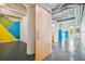 An open floor plan with blue and yellow geometric accents and concrete beam at 101 N 12Th St # 306, Tampa, FL 33602