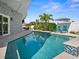 Stunning pool with lush landscaping, and features a patio area with comfortable seating at 11098 Malaga Dr, Largo, FL 33774