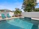 Relaxing pool area with lounge chairs, well manicured plants, and a privacy fence perfect for outdoor enjoyment at 11098 Malaga Dr, Largo, FL 33774