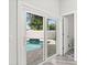 View of backyard pool and spa through glass doors from inside the home at 11098 Malaga Dr, Largo, FL 33774