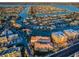 Expansive aerial view showcasing waterfront property with boat docks and residential buildings near the Intracoastal Waterway at 11595 Gulf Blvd # 6, Treasure Island, FL 33706