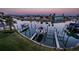 Aerial view featuring boat docks and waterfront homes during an evening sunset at 11595 Gulf Blvd # 6, Treasure Island, FL 33706