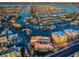 Expansive aerial view of a waterfront condominium community with a pool and waterway access at 11595 Gulf Blvd # 6, Treasure Island, FL 33706